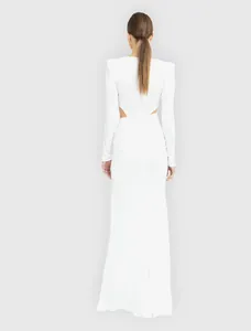Back view of elegant white floor-length dress with side cut-out details and shoulder pads