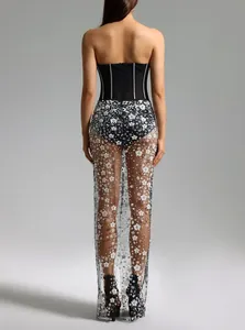 Rear view detail of a strapless black corset gown with sheer floral sequined mesh skirt