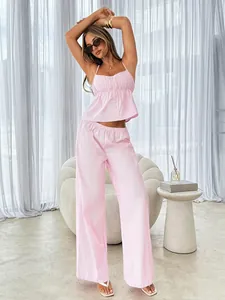 Pink striped camisole and wide-leg trousers set modeled in a bright living room