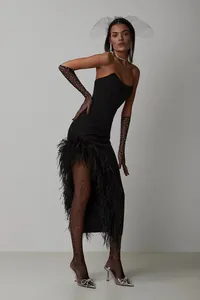 Detail view of black strapless evening gown with ostrich feathers and asymmetrical slit