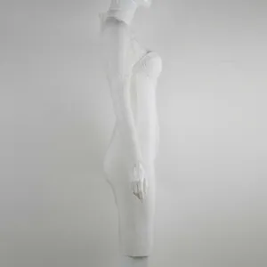 Side view of elegant white bandage dress featuring long lace sleeves on white mannequin