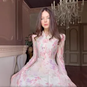 Elegant white long-sleeved dress featuring delicate purple and pink floral prints on a slim fit.