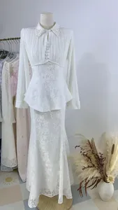 Elegant white lace long sleeve pleated dress with pearl collar detail shown on mannequin