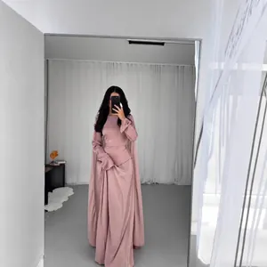 Close-up detail of a dusty pink long sleeve maxi dress featuring elegant ruffled bell cuffs
