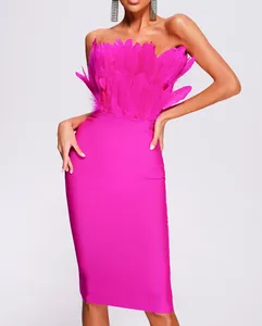 Detail view of vibrant pink strapless bandage dress with fluffy ostrich feathers.