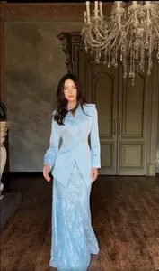 Full view of elegant light blue textured two-piece blazer and floral long skirt suit for women