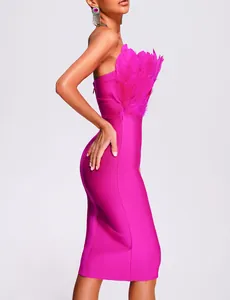 Side view detail of a fuchsia strapless bandage dress featuring lush ostrich feather trim.
