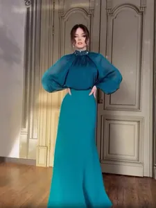 Elegant teal French evening gown featuring sheer puff sleeves and decorative high neck collar