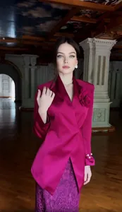 Elegant pink satin textured blazer with a large 3D rose paired with a purple lace skirt.