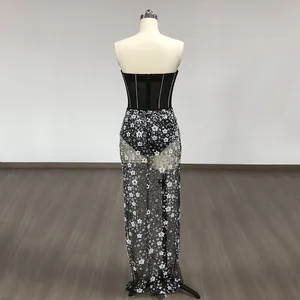 Back view of a mesh banquet gown with intricate sequined floral embroidery on a mannequin