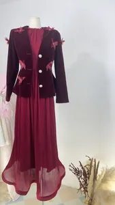 Mannequin display showing a burgundy velvet jacket paired with a matching pleated maxi dress