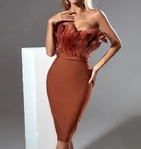 Close-up of elegant terracotta bandage dress featuring luxury ostrich feather bodice details