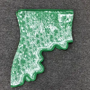 Detailed macro view of the irregular scalloped hem on a green jacquard strapless top