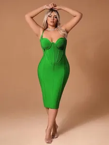 Detail shot of green bodycon bandage dress with corset-style bust and thin straps