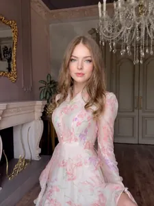Elegant long-sleeved floral dress with ruffles in a classic European interior setting
