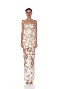 Detailed view of white 3D floral appliqués on a strapless sheer mesh long evening gown
