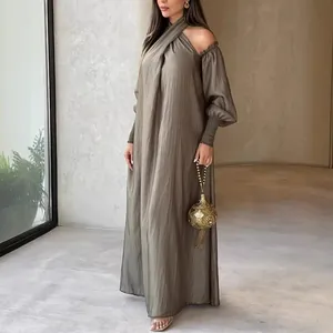 Elegant taupe long-sleeved maxi dress with cold-shoulder design and flowy silhouette
