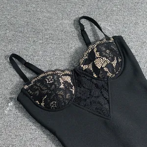 Close-up detail of a elegant black bandage dress featuring intricate floral lace bustier design