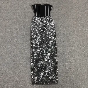 Detail view of a strapless sequined floral evening gown with a striped black bodice.