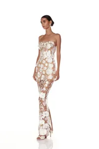 Detailed view of elegant white 3D flower applique on a strapless mesh evening gown