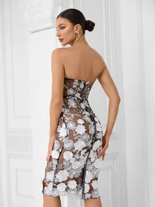 Detailed back view of an elegant strapless mesh dress with white floral embroidery for parties