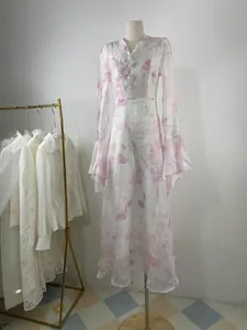 Elegant long-sleeved floral maxi dress featuring romantic ruffles and a chic V-neckline