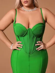 Close-up detail of a vibrant green plus size bandage midi dress with corset bodice