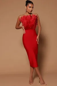 Elegant red strapless bandage dress with ostrich feather detail on the bodice.