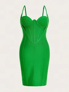 Detail of green bandage bodycon dress with structured corset bodice and thin straps.