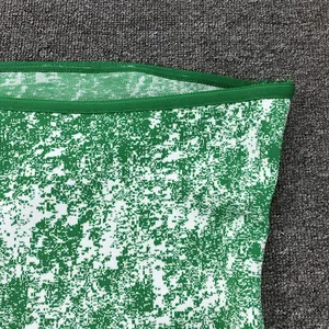 Close-up detail of green and white jacquard knit fabric on a stylish strapless tube top
