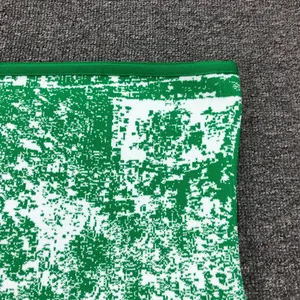 Detail macro view of green and white jacquard knit fabric for fashion party dress