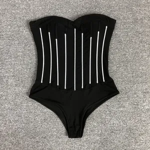 Close-up detail of a sexy black strapless bodysuit featuring vertical white sequin stripes