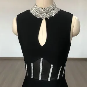 Exquisite detail of a high neck black bandage dress featuring sparkling rhinestones and mesh cutout