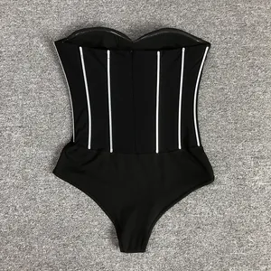 Detailed view of black strapless bodysuit with white vertical sequin stripes.