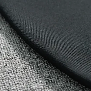 Detailed macro view showing the high-density black bandage dress fabric texture and weave