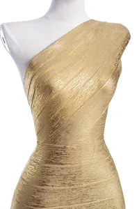 Close-up of gold foil bandage dress showing one-shoulder detail and metallic texture