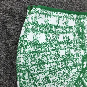 Close-up of green jacquard mini skirt with high-quality side hidden zipper detail.