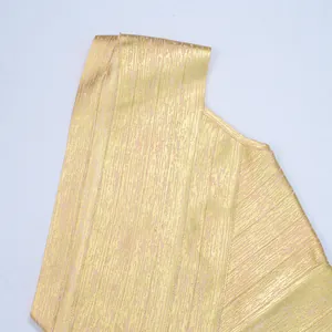 Close-up macro view showing metallic gold foil texture on a sexy one-shoulder bandage dress