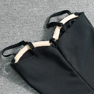 Detail view of a black backless bandage dress showing straps and hidden zipper closure