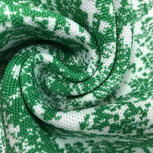 Macro view of the green and white floral jacquard knit fabric showing soft texture.