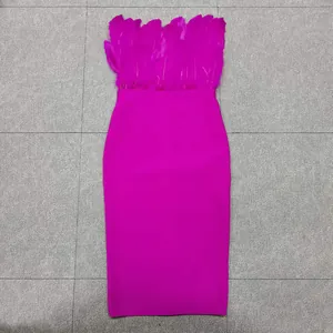 Detail view of magenta strapless bandage dress with elegant ostrich feather trim