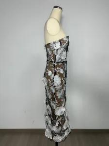 Side detail of strapless evening gown featuring silver floral embroidery on mesh