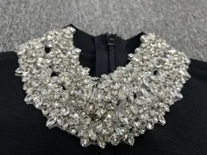 Exquisite close-up of sparkling rhinestone collar detail on a sexy black bandage dress