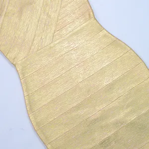 Detailed view of the textured gold foil metallic fabric on a sexy bandage bodycon dress