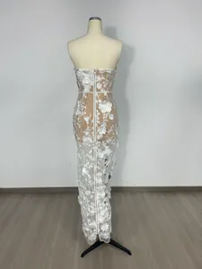 Back view of elegant white 3D floral lace maxi dress with nude lining on mannequin.