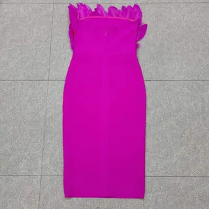 Detailed back view of fuchsia strapless bandage dress with elegant ostrich feathers
