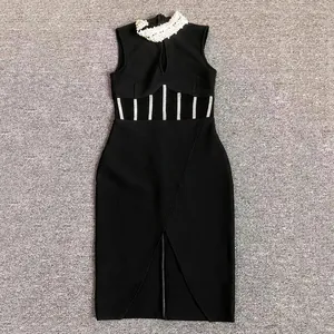 Detail view of a black high-neck bandage dress with rhinestones and mesh cutouts.