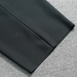 Macro detail of high-quality black elastic bandage dress fabric showing ribbed texture