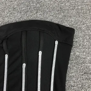 Macro detail of sexy black mesh sleeveless bodysuit featuring silver sequin beaded strips