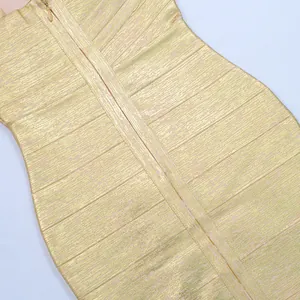 Close-up of gold foil metallic fabric on a bandage bodycon dress showing zipper detail